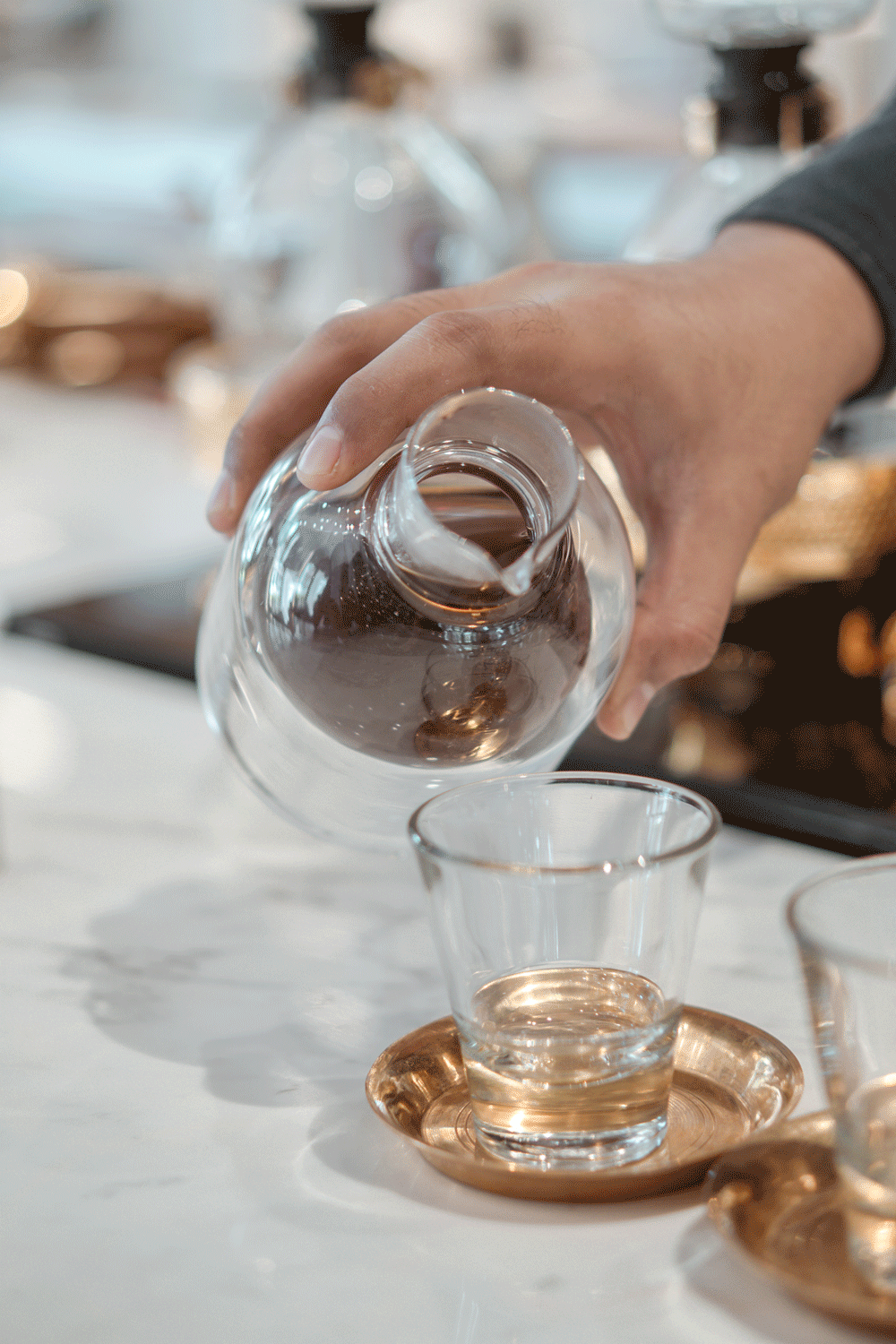 coffee being poured at Singapore Coffee in Raffles Hotel, Photography by Melissa C Koh | melissackoh.com